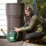 Woman gardening next to rattan butt